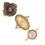 A selection of three 9ct gold gem-set rings. To include a cultured pearl ring, a pear-shape coated