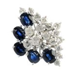 A sapphire and diamond dress ring. Of marquise-shape outline, the brilliant-cut diamond cluster,