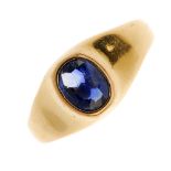 A 1930s 18ct gold sapphire ring. The oval-shape sapphire, within a collet mount, to the tapered