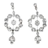 A pair of diamond ear pendants. Each designed as a circular-cut diamond, within a single-cut diamond