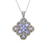 A 9ct gold tanzanite and diamond floral pendant. The circular-shape tanzanite cluster, within an