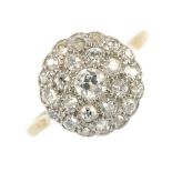 A mid 20th century 18ct gold diamond cluster ring. The old-cut diamond, within an old-cut diamond