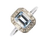 An aquamarine and diamond cluster ring. The rectangular-shape aquamarine, within a single and