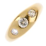 An early 20th century 18ct gold diamond three-stone ring. The graduated old-cut diamond line,