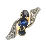 A mid 20th century gold sapphire and diamond dress ring. The three circular-shape sapphires, to