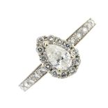 (174792) A diamond cluster ring. The pear-shape diamond, within a brilliant-cut diamond surround, to