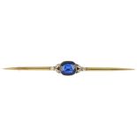 A mid 20th century synthetic sapphire and diamond bar brooch. The cushion-shape synthetic sapphire