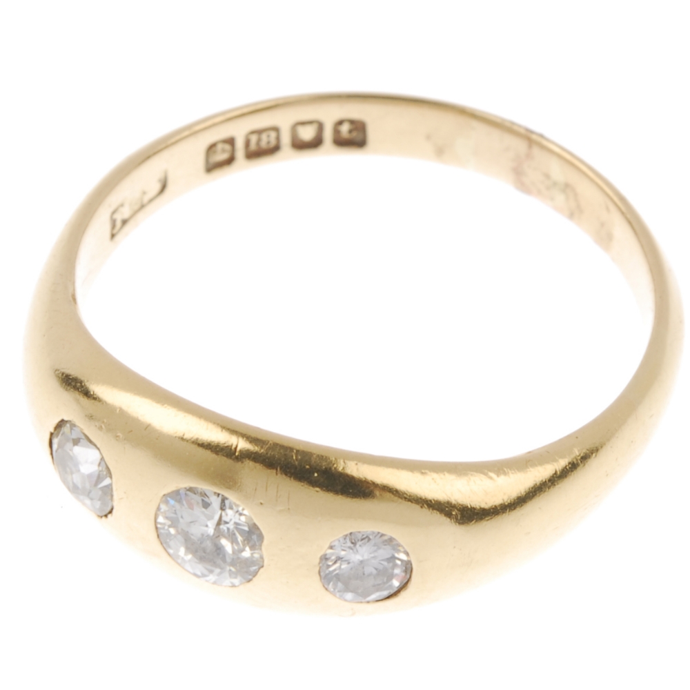 An early 20th century 18ct gold diamond three-stone ring. The graduated old-cut diamond line, - Image 2 of 2