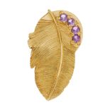 An 18ct gold amethyst pendant. Designed as a textured feather, with circular-shape amethyst line