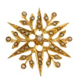 An early 20th century gold split pearl brooch. Of openwork design, the six-ray star, with floral