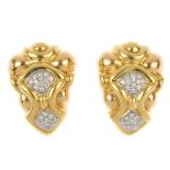 A pair of diamond earrings. Each designed as two brilliant-cut diamond curved panels, within a