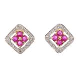 A pair of 9ct gold ruby and diamond ear studs. Each of openwork design, the circular-shape ruby