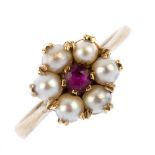 A 1950s 9ct gold ruby and split pearl cluster ring. The circular-shape ruby, within a split pearl