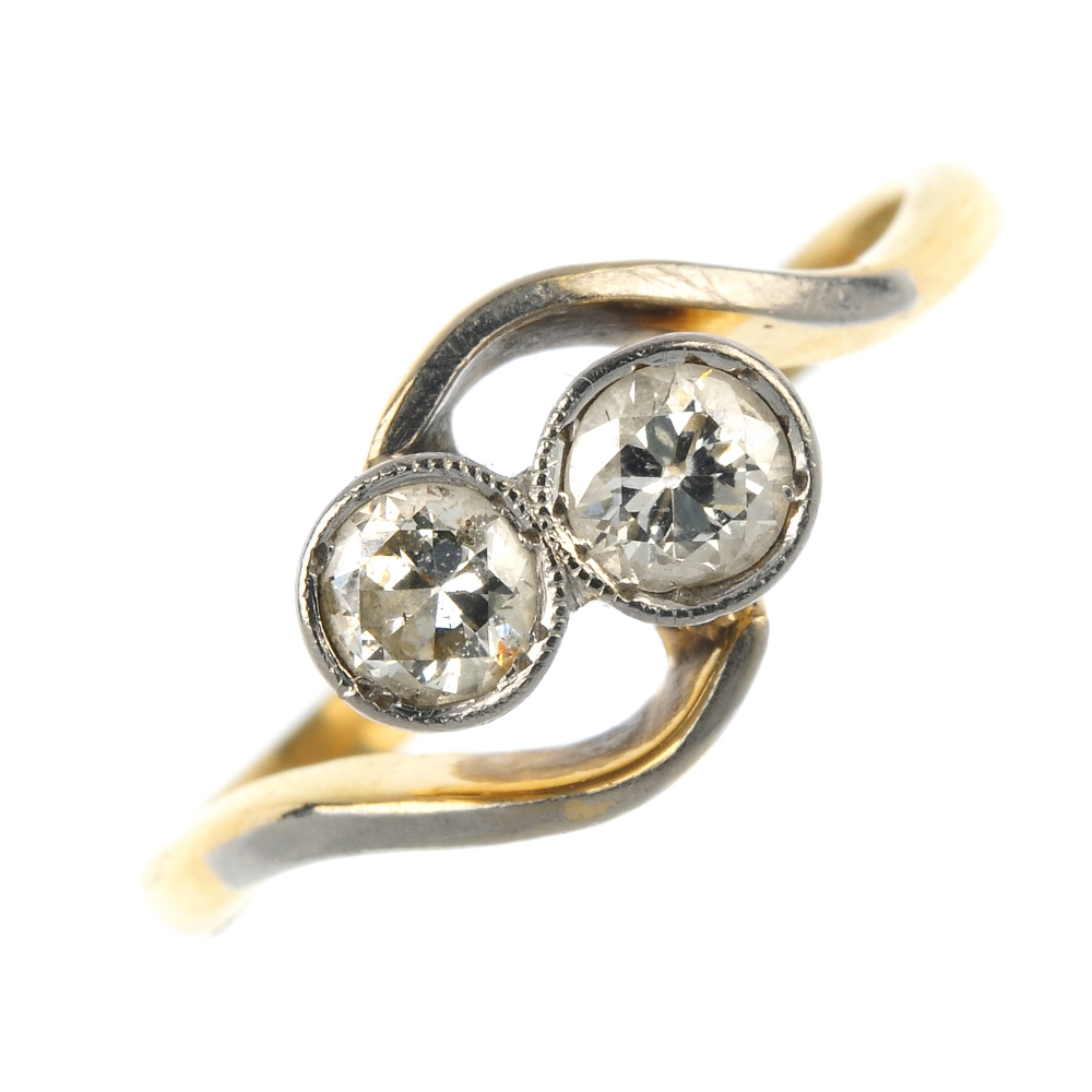A mid 20th century 18ct gold and platinum diamond two-stone ring. The old-cut diamond collets, to
