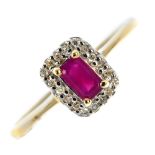 A 9ct gold ruby and diamond cluster ring. The rectangular-shape ruby, within a single-cut diamond