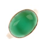 A mid 20th century gold dyed chalcedony single-stone ring. The oval dyed chalcedony cabochon, to the