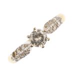 A diamond single-stone ring. The brilliant-cut diamond, to the pave-set diamond shoulders and