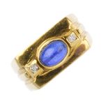 A synthetic sapphire and cubic zirconia dress ring. The oval synthetic sapphire cabochon, with