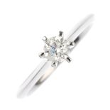An 18ct gold diamond single-stone ring. The brilliant-cut diamond, to the knife-edge shoulders and