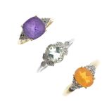 A selection of three 9ct gold gem-set rings. To include an amethyst and diamond dress ring, a fire