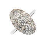 A diamond panel ring. Of oval outline, the three graduated circular-cut diamonds, within a single-