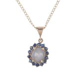 A set of sapphire jewellery. The pendant designed as an oval star sapphire cabochon, within a