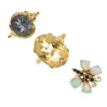 A selection of three gem-set rings. To include an opal and sapphire butterfly ring, a coated topaz