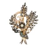 A cultured pearl and diamond floral brooch. The cultured pearl flower and diamond point leaves,