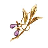 A paste spray brooch. The pear-shape purple pastes, to the foliate spray surmount. Length 5.6cms.