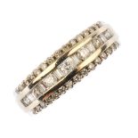 An 18ct gold diamond three-row ring. The alternating brilliant and baguette-cut diamond line, within