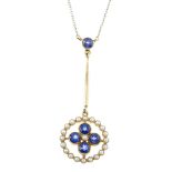 An early 20th century 15ct gold sapphire and split pearl pendant. The circular-shape sapphire