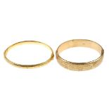 Two 9ct gold bangles. To include a foliate engraved bangle and a Greek-key design hinged bangle.