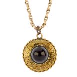 A late 19th century garnet single-stone pendant. The circular garnet cabochon, within a bead and