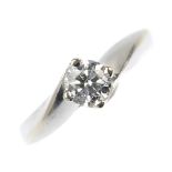 A diamond single-stone ring. The brilliant-cut diamond, weighing 0.50ct, to the asymmetric shoulders