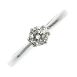 An 18ct gold diamond single-stone ring. The brilliant-cut diamond, to the tapered shoulders and