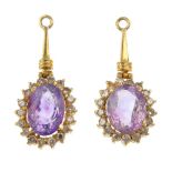 A pair of amethyst and diamond cluster drops. Each designed as an oval-shape amethyst, within a