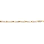 An early 20th century gate bracelet. Designed as a series of three-bar links, to the partially