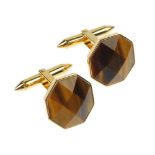 A pair of 18ct gold tiger's-eye cufflinks. Each designed as a faceted tiger's-eye dome, to the