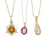 A selection of three pendants. To include a 9ct gold citrine flower pendant, an opal and ruby