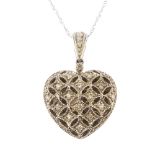 A diamond heart locket. Of geometric design, the brilliant-cut diamond openwork lattice front,