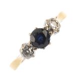 A mid 20th century platinum and 18ct gold sapphire and diamond three-stone ring. The circular-