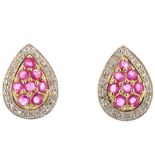 A pair of 9ct gold ruby and diamond ear studs. Each of pear-shape outline, the pave-set ruby