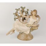 A large Lladro figure of a young girl, modelled reclining upon a tree stump, wearing flowing shawl