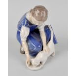 A Bing & Grondahl porcelain figure, modelled as a young girl in blue dress, kneeling to feed cat