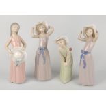 A group of seven Lladro figures, each similarly modelled as young female in plain coloured dress and