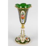 A Bohemian overlay green glass vase, of trumpet form with shaped rim, having alternate floral and