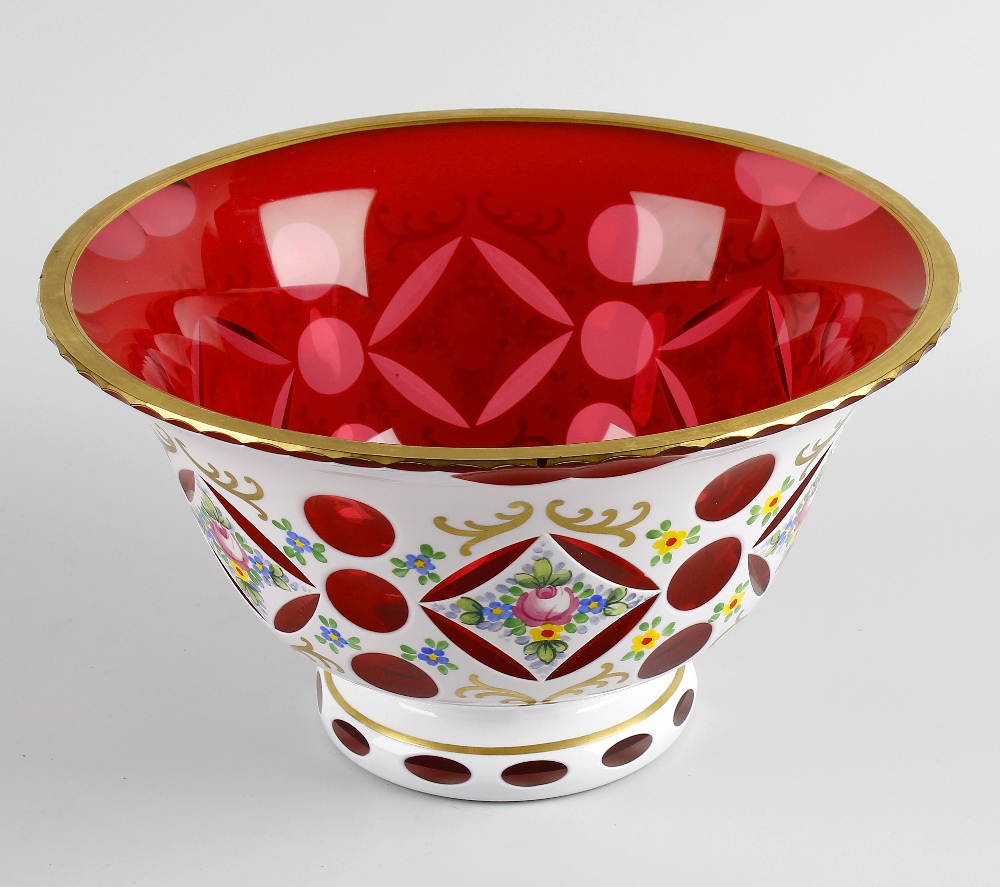 A Bohemian white flash overlay cranberry glass bowl, of flared form raised upon conforming