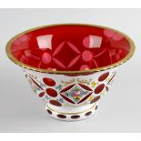 A Bohemian white flash overlay cranberry glass bowl, of flared form raised upon conforming
