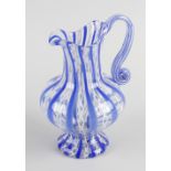 An Anglo Venetian glass water jug, of bulbous form having tall neck and shaped spout, with scroll