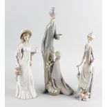 Three Lladro figures, the first modelled as tall male holding violin, stood beside kneeling female